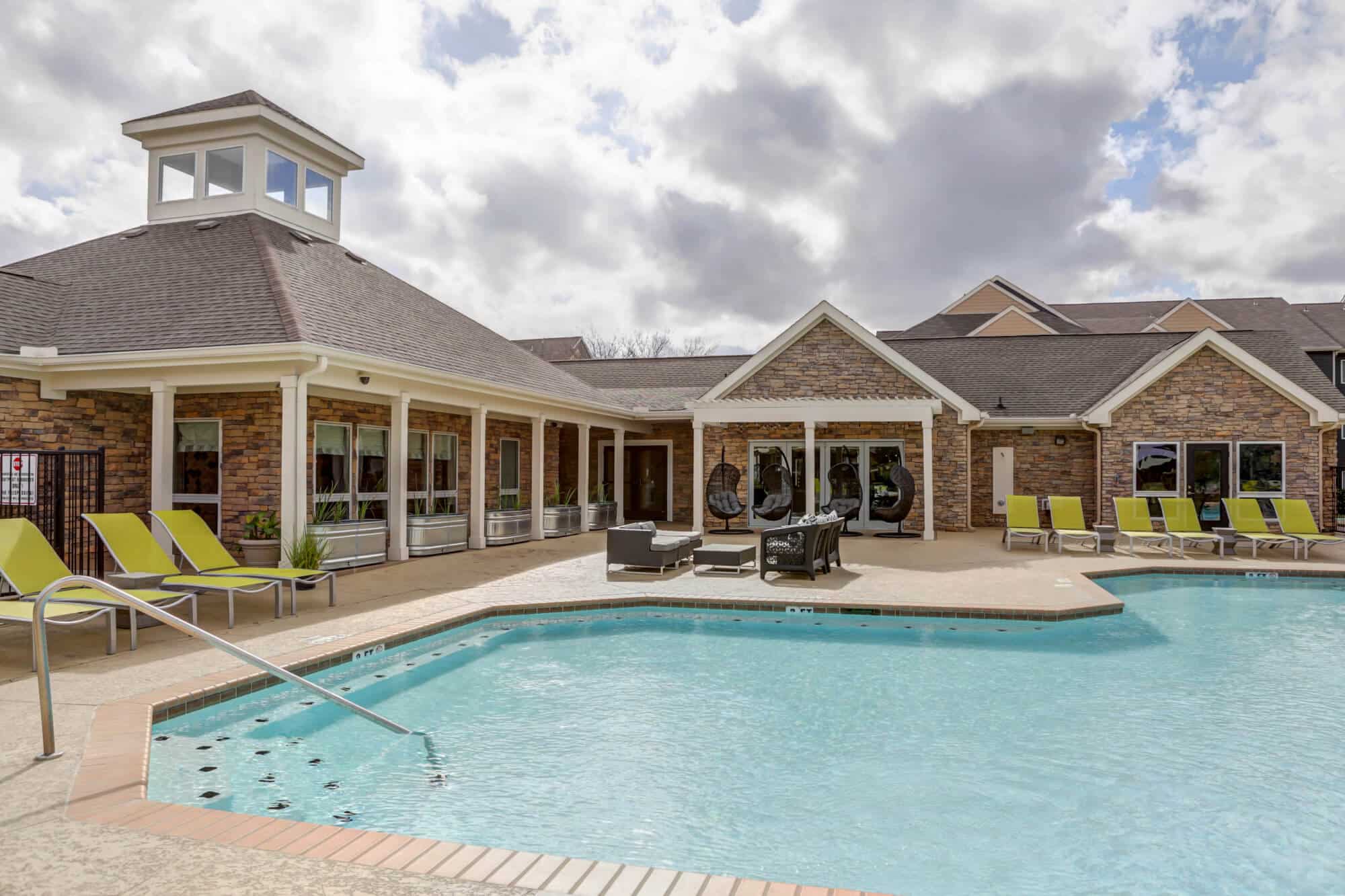 the outpost san marcos off campus apartments near texas state university resort style pool resident clubhouse exterior