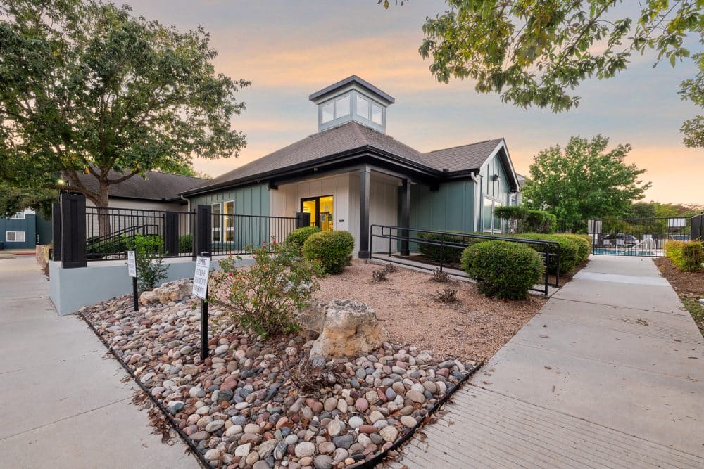 the outpost san marcos apartments near texas state university leasing office and clubhouse exterior